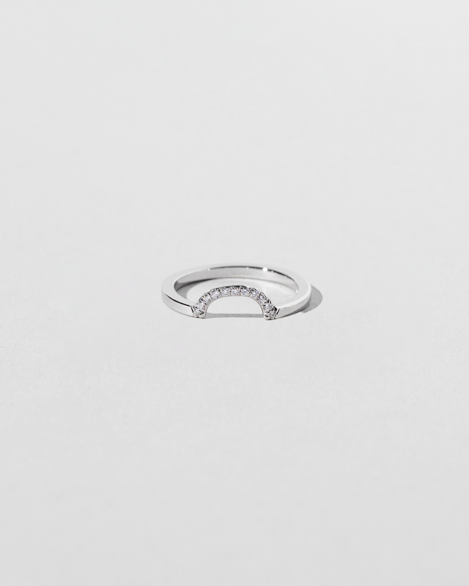 Platinum Pavé Mini Half Hoop Band on light color background.