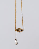 Pearl State Shifter Necklace on light color background.