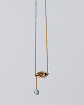 Turquoise State Shifter Necklace on light color background.