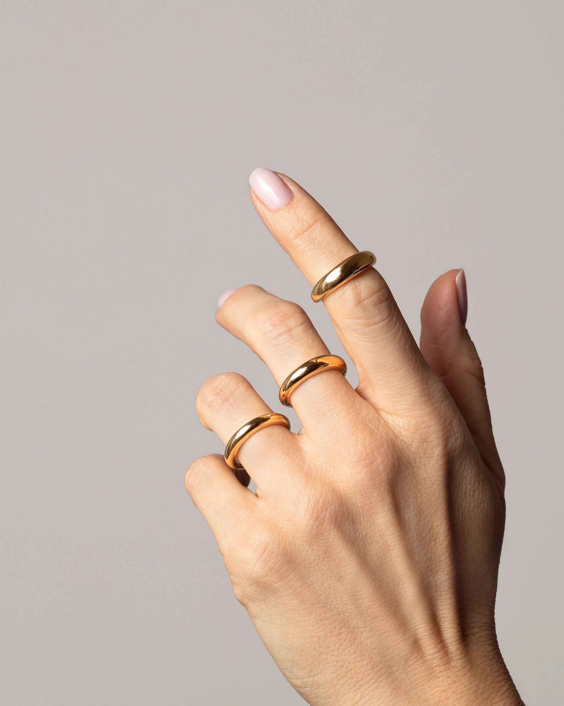 2.5mm,  4.5mm and 5.5mm Gold Venus Bands on model.
