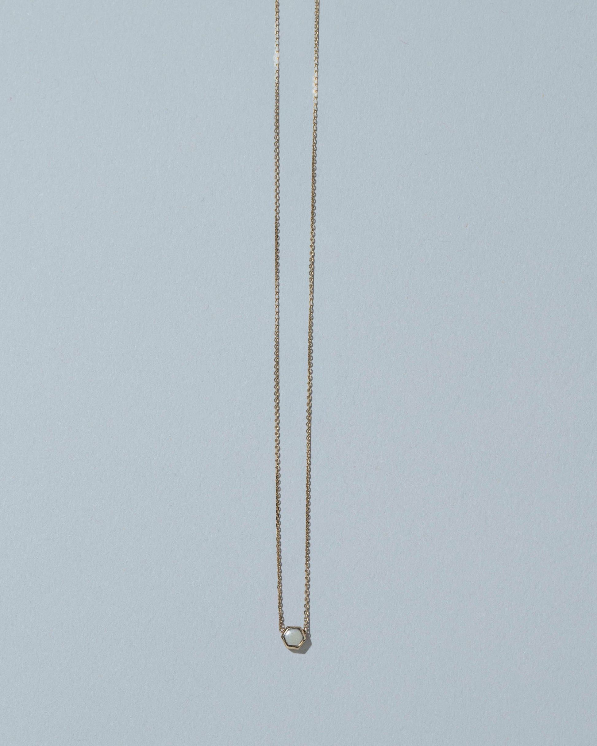 Snowdrift Agate Hexagon Necklace on light color background.