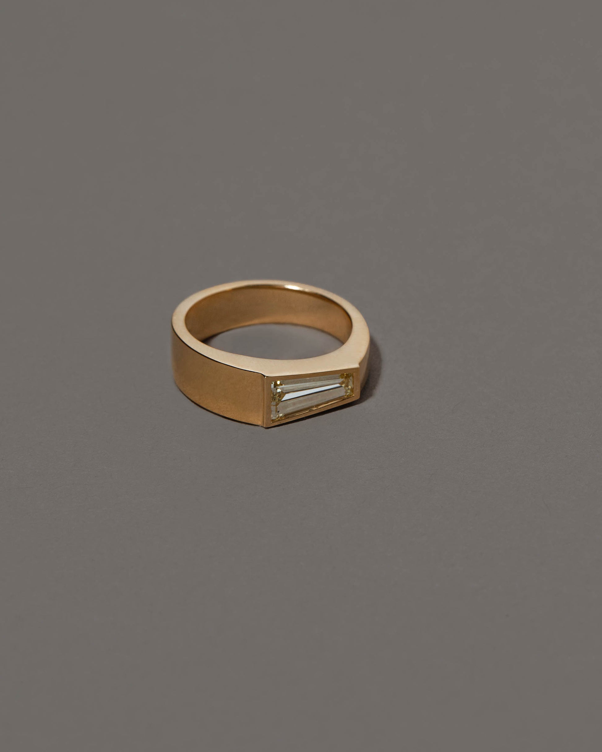 View from the side of the Joviality Ring on grey color background.