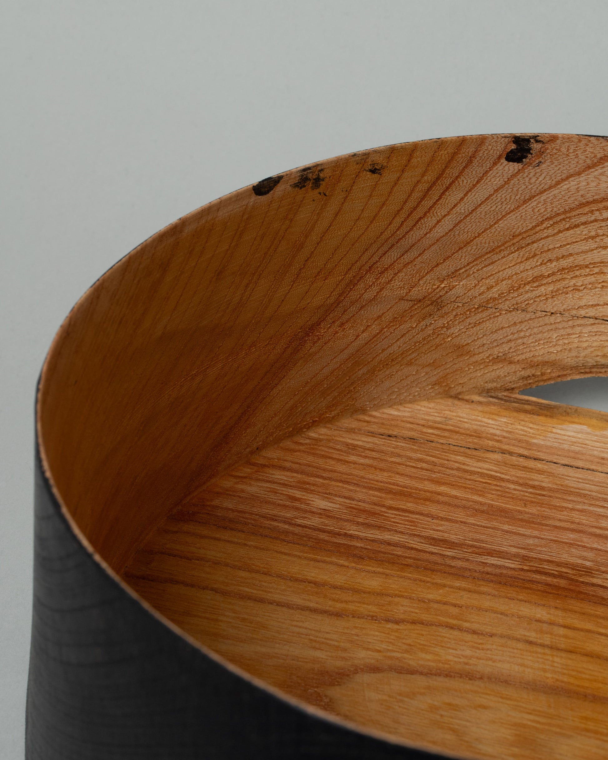 Closeup details of the Namu Home Goods Medium Zelkova Wood Black Lacquered Vessel on light color background.