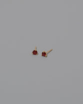 Magenta Ruby Martini Stud Earrings on light color background.