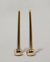 Pearce Objects Cast Bronze Globular Candle Holder Set with candles on light color background.