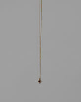 Ruby Birthstone Level Necklace on light color background.