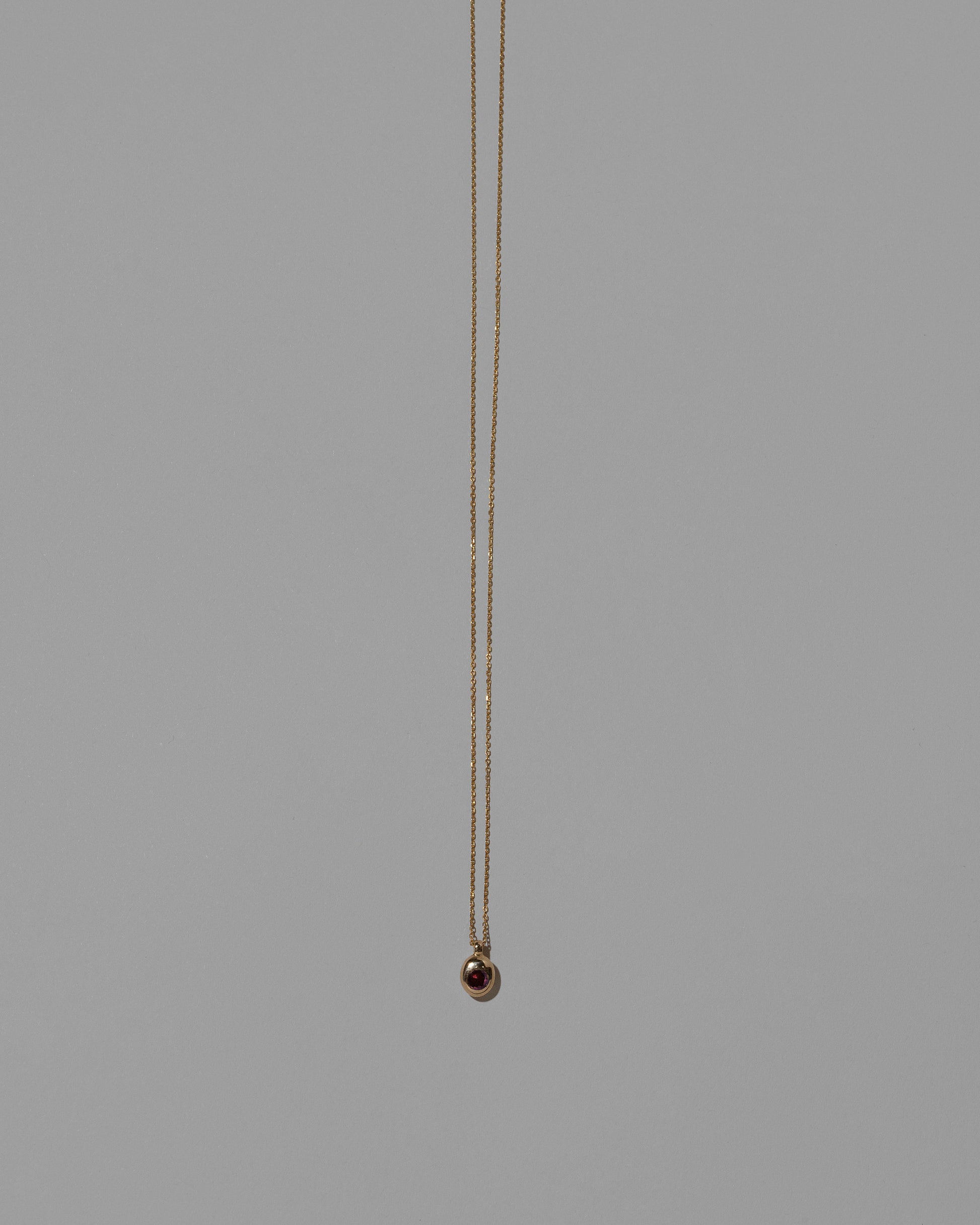 Ruby Birthstone Level Necklace on light color background.
