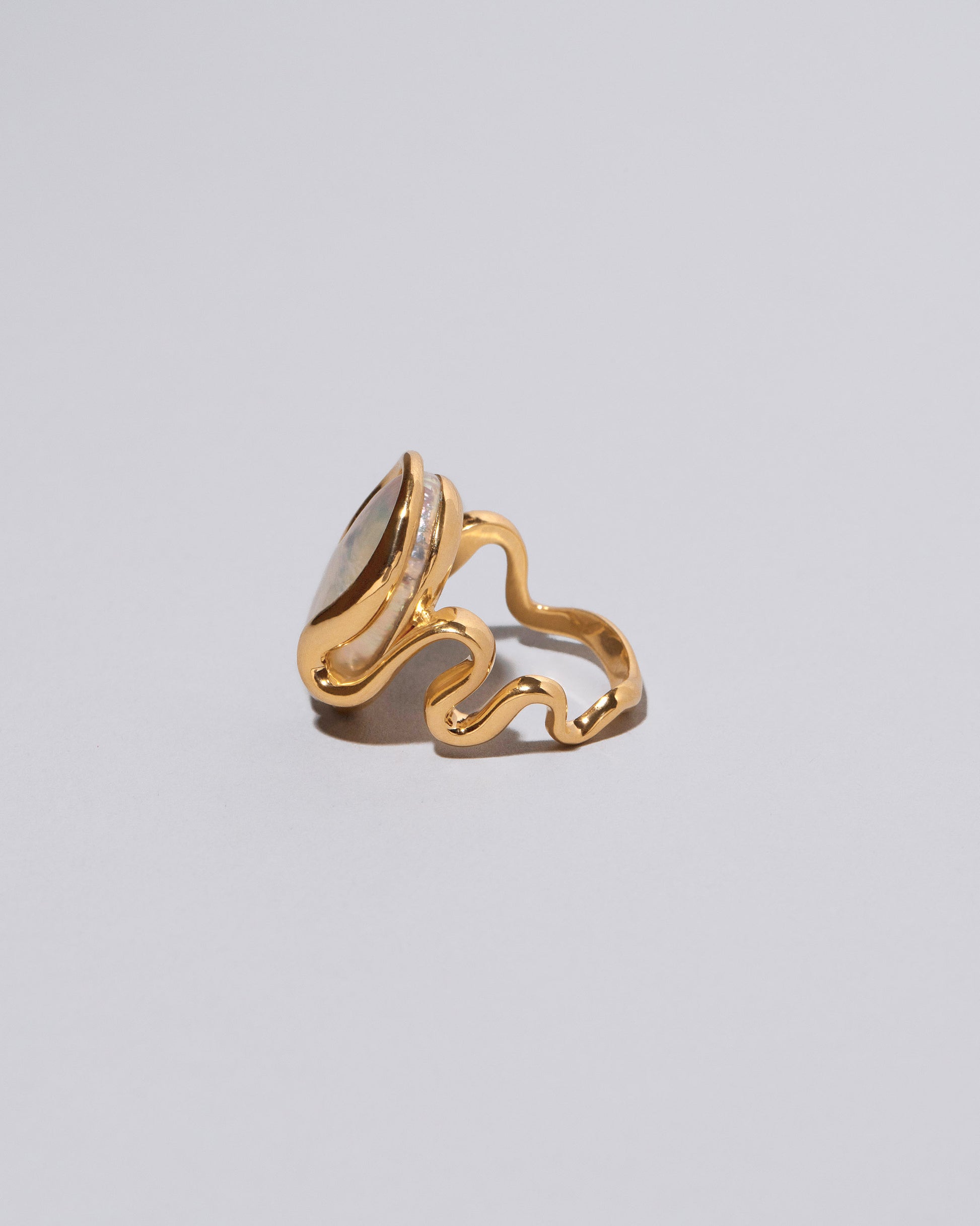 View from the side of the Weaver Ring on light color background.