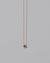 Gold Bicolor Blue Sapphire Level Necklace on light color background.