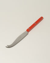 Sabre Paris Red Cheese Knife on light color background.