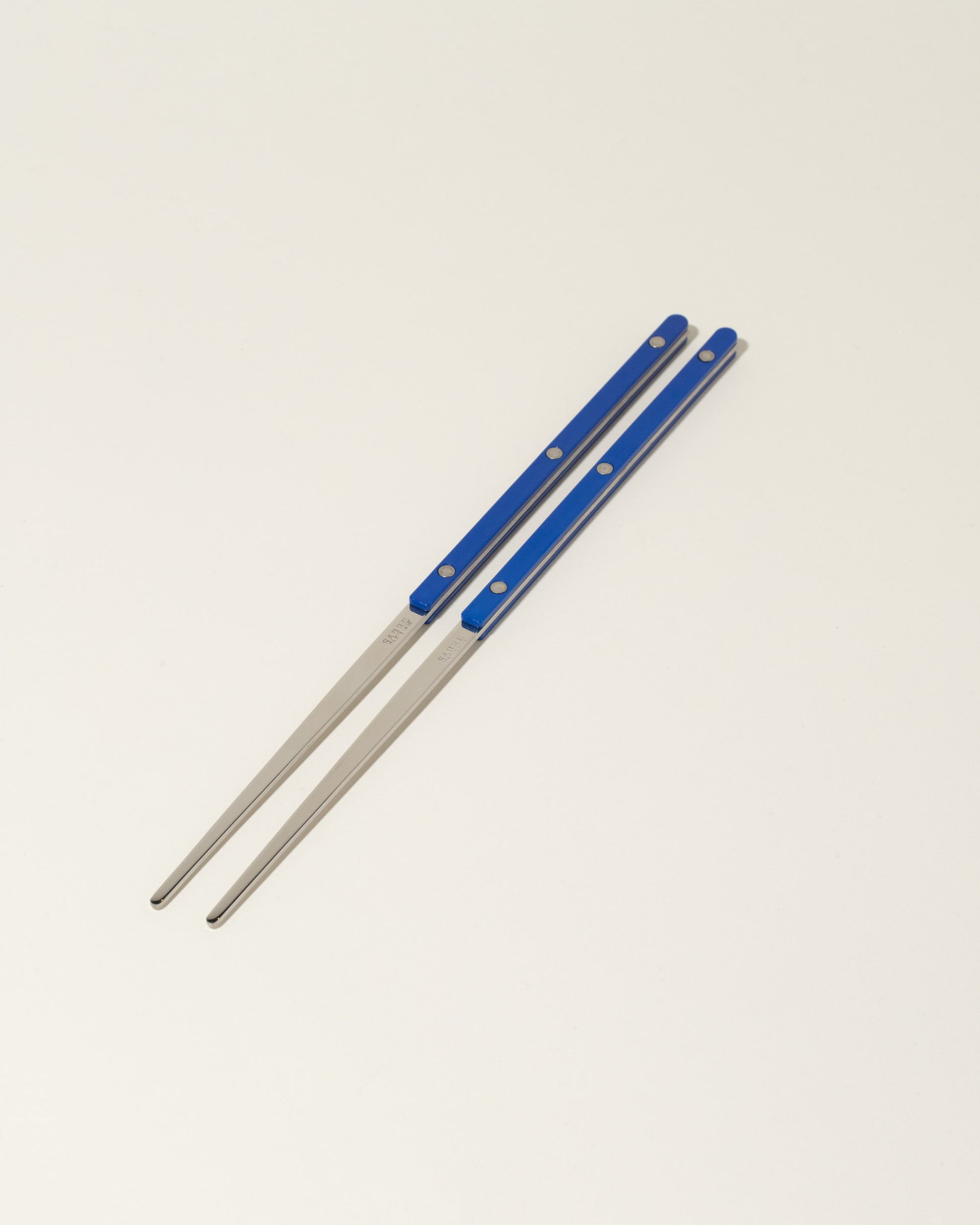 Sabre Paris Yellow Chopsticks on light color background.