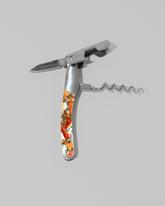 Detail view of the Santa Fe Stoneworks Spiney Oyster Waiter's Knife on light color background.