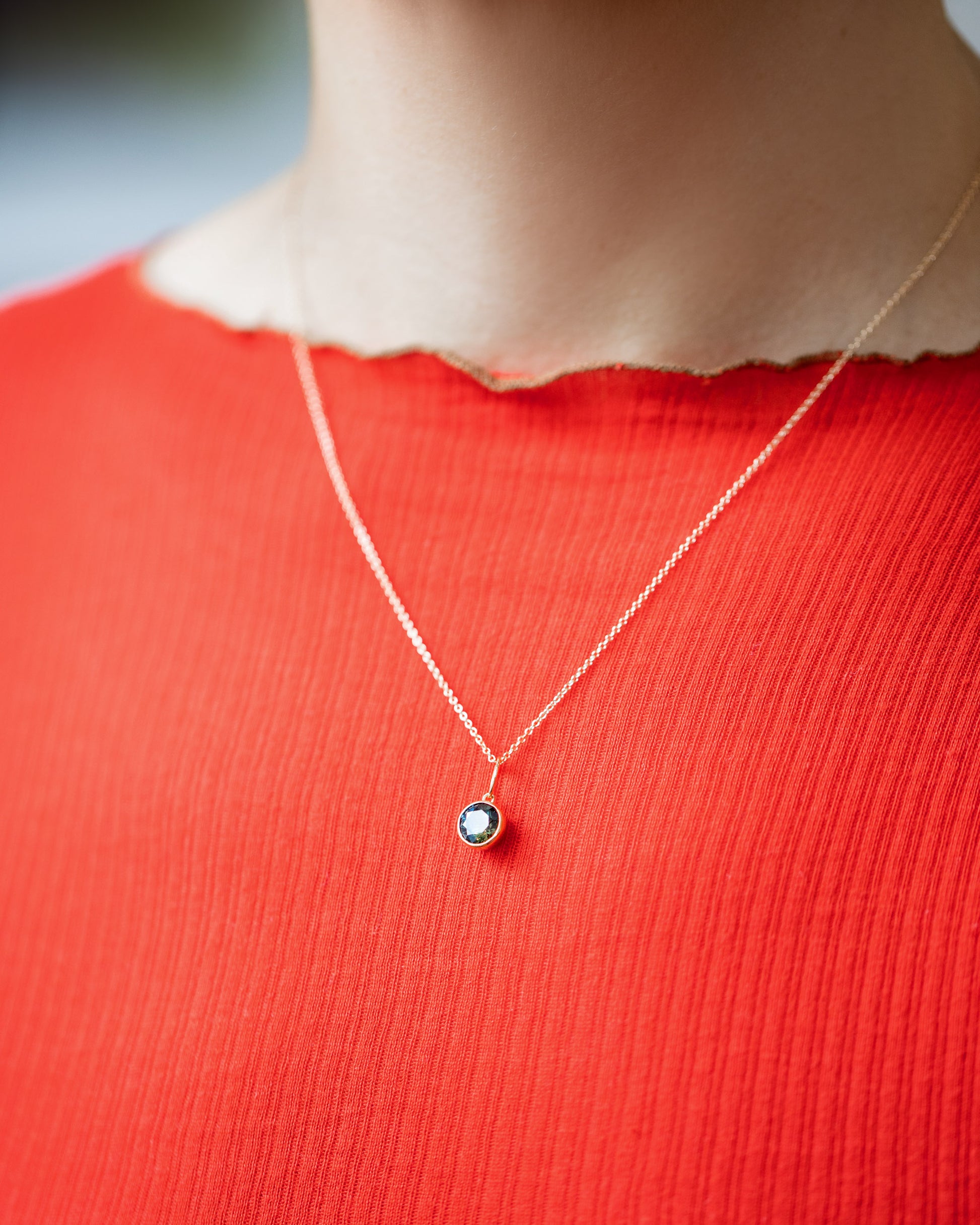 Bicolor Sapphire Pendant paired with chain on model.