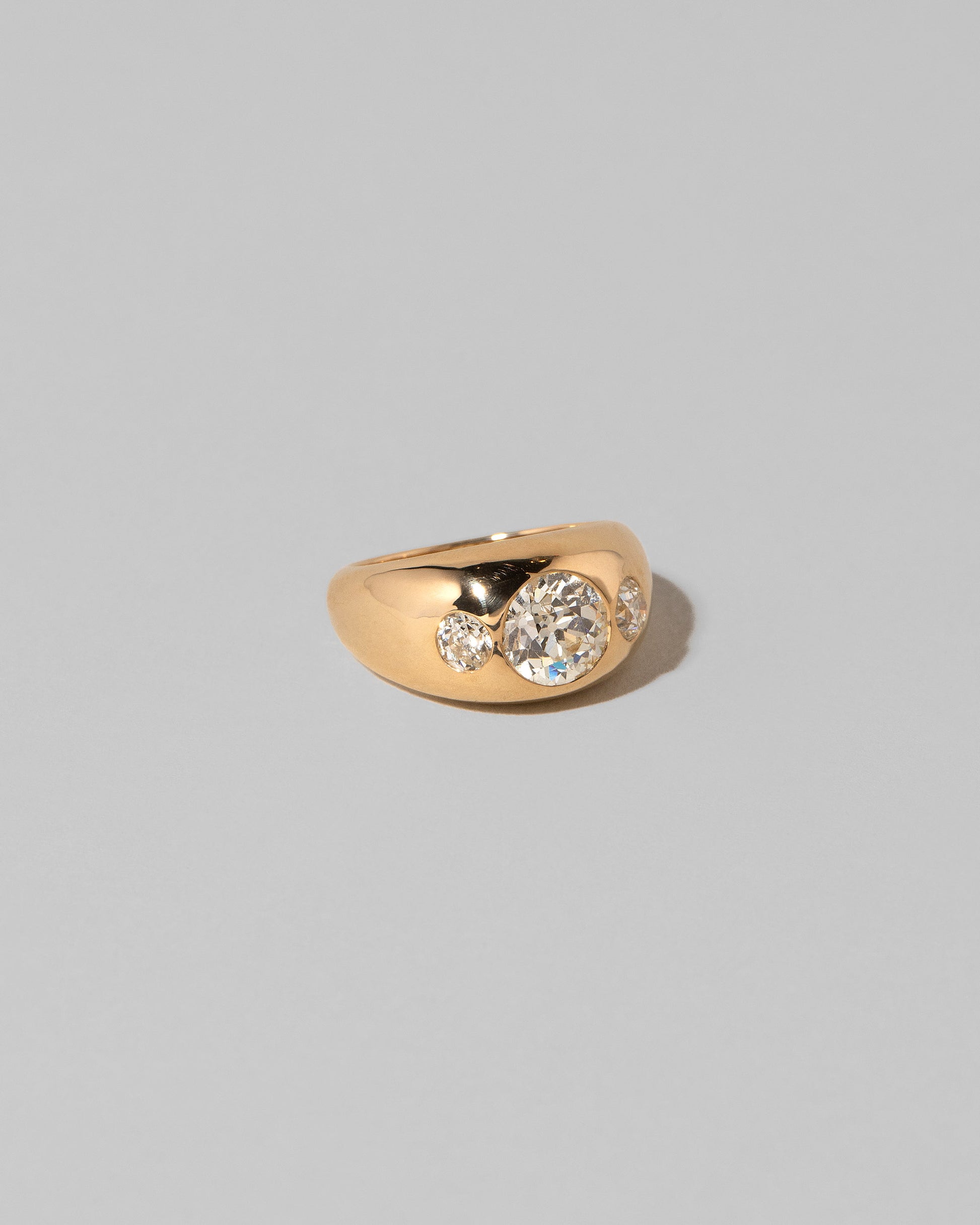 View from the side of the Diamond Saturn Ring on light color background.