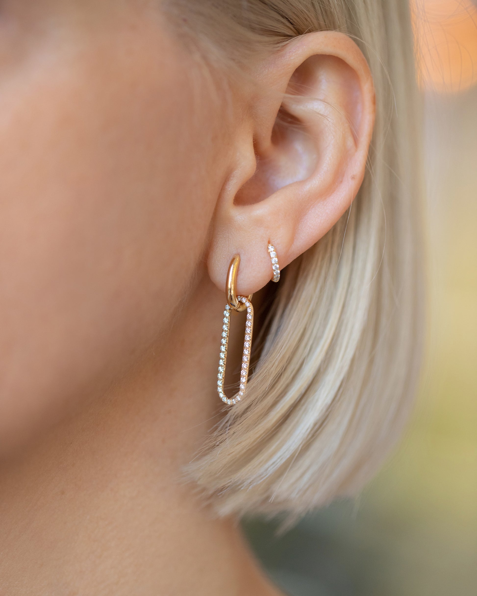 Gold Huggies Diamond Snack Hoop Earring and Pavé Link Huggie Hoop Earring on model.