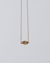 State Shifter Necklace on light color background.