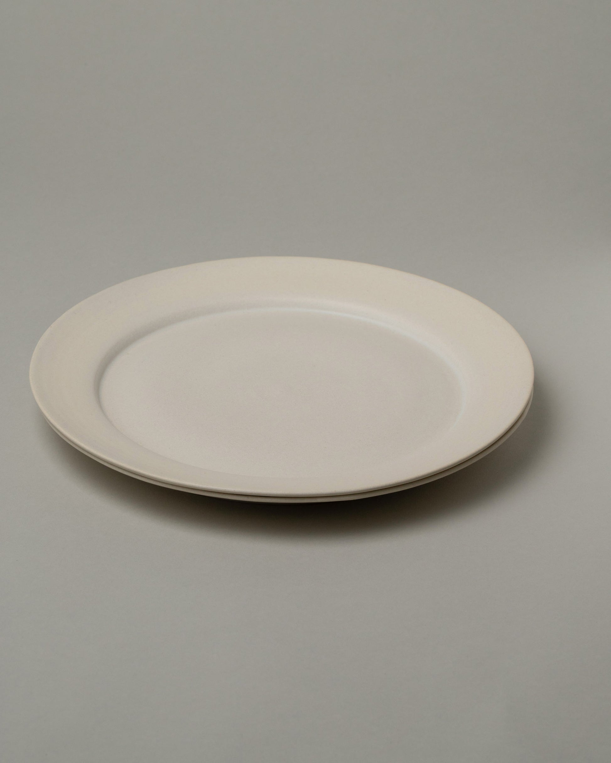 Tracie Hervy Dinner Plates Set on light color background.