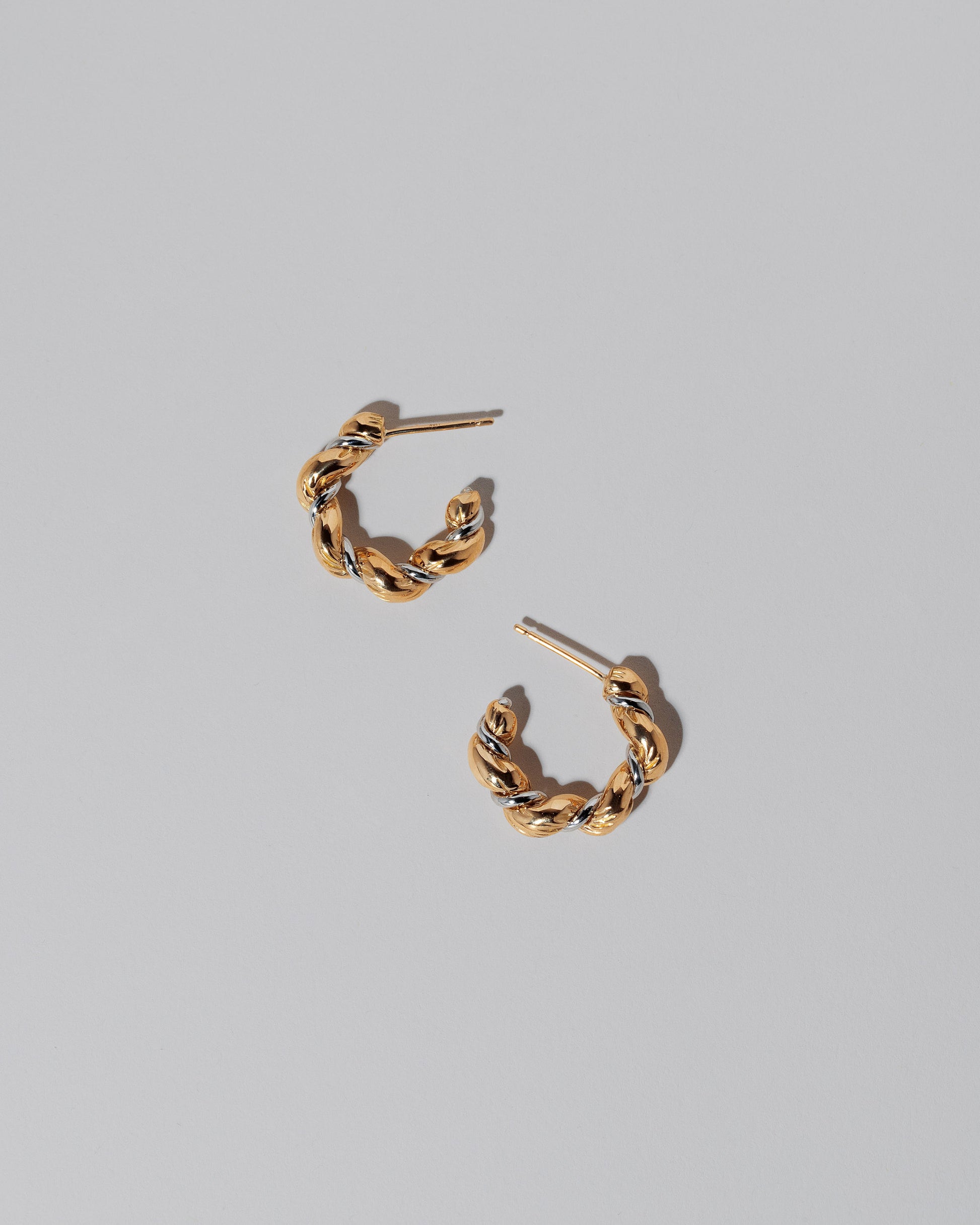 Two Tone Wrapped Hoop Earrings on light color background.