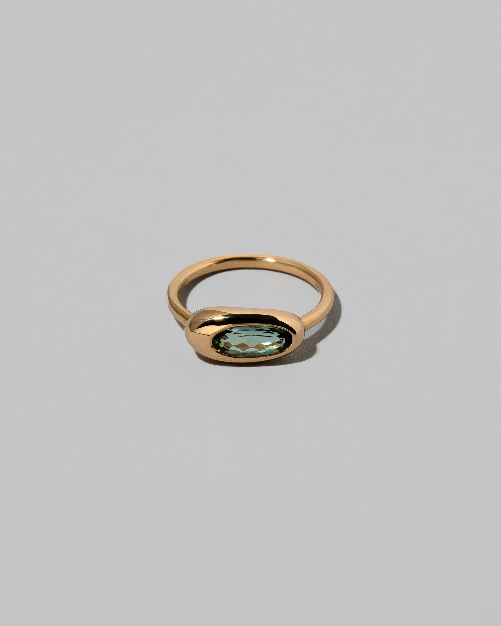 Tourmaline Equalize Ring on light color background.
