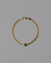 Gold Emerald Fold Bracelet on light color background.