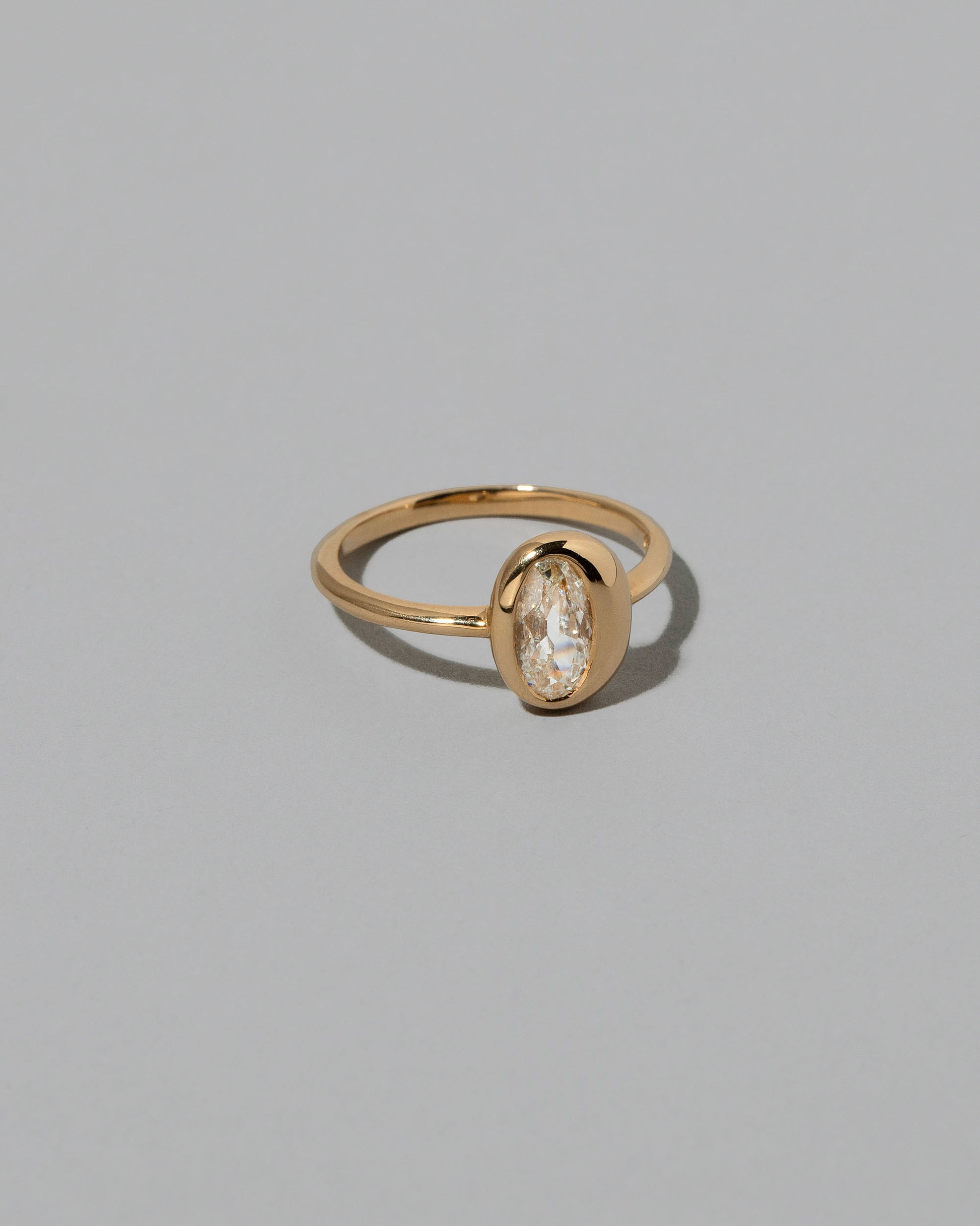 View from the side of the Moval Diamond Precise Ring on light color background.