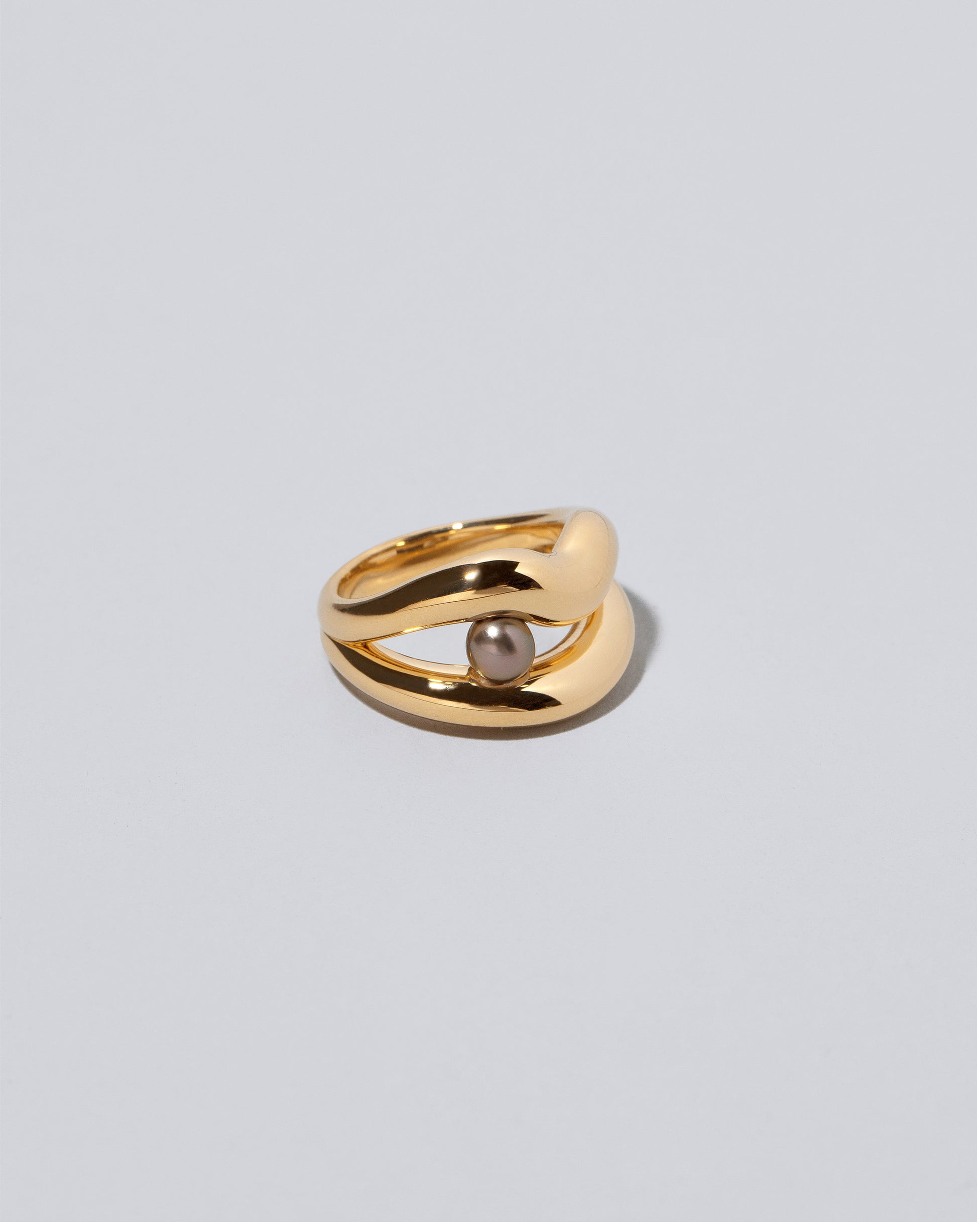 Closeup details of the Ocean of Unity Ring on light color background.