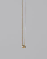 Gold Diamond Level Necklace on light color background.
