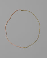 Half Oval Chain & Peony Seed Pearl Necklace on light color background.