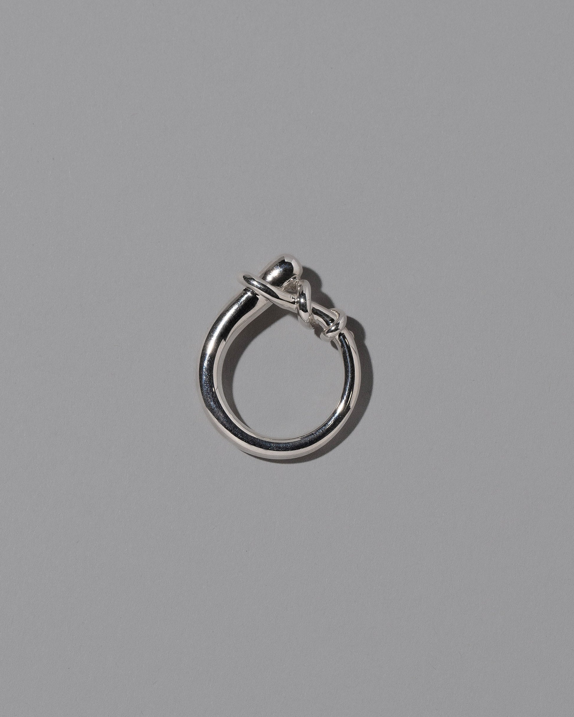 View from the side of the CRZM Sterling Silver Terrane Ring on light color background.