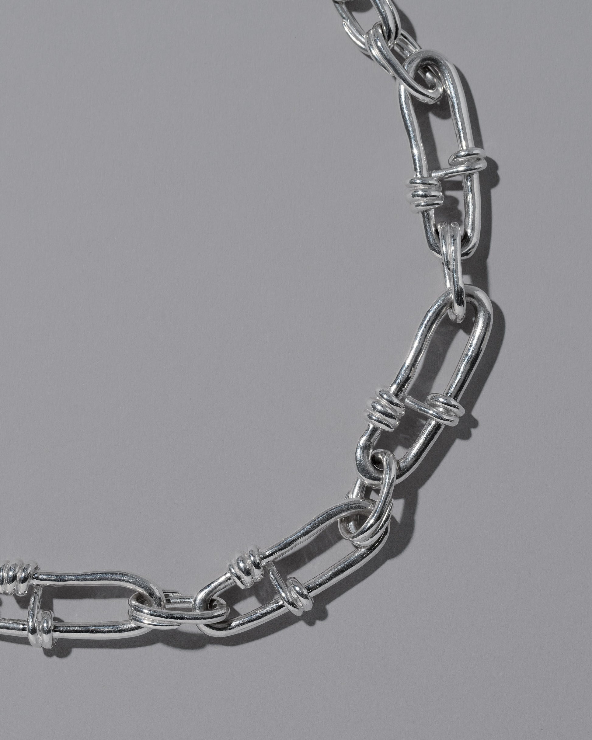 Closeup details of the CRZM Sterling Silver Canyon Bracelet on light color background.