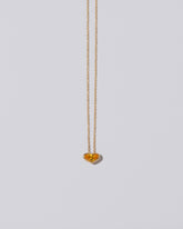 Venus Heart Pendant on light color background.