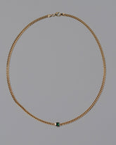Emerald Fold Necklace on light color background.