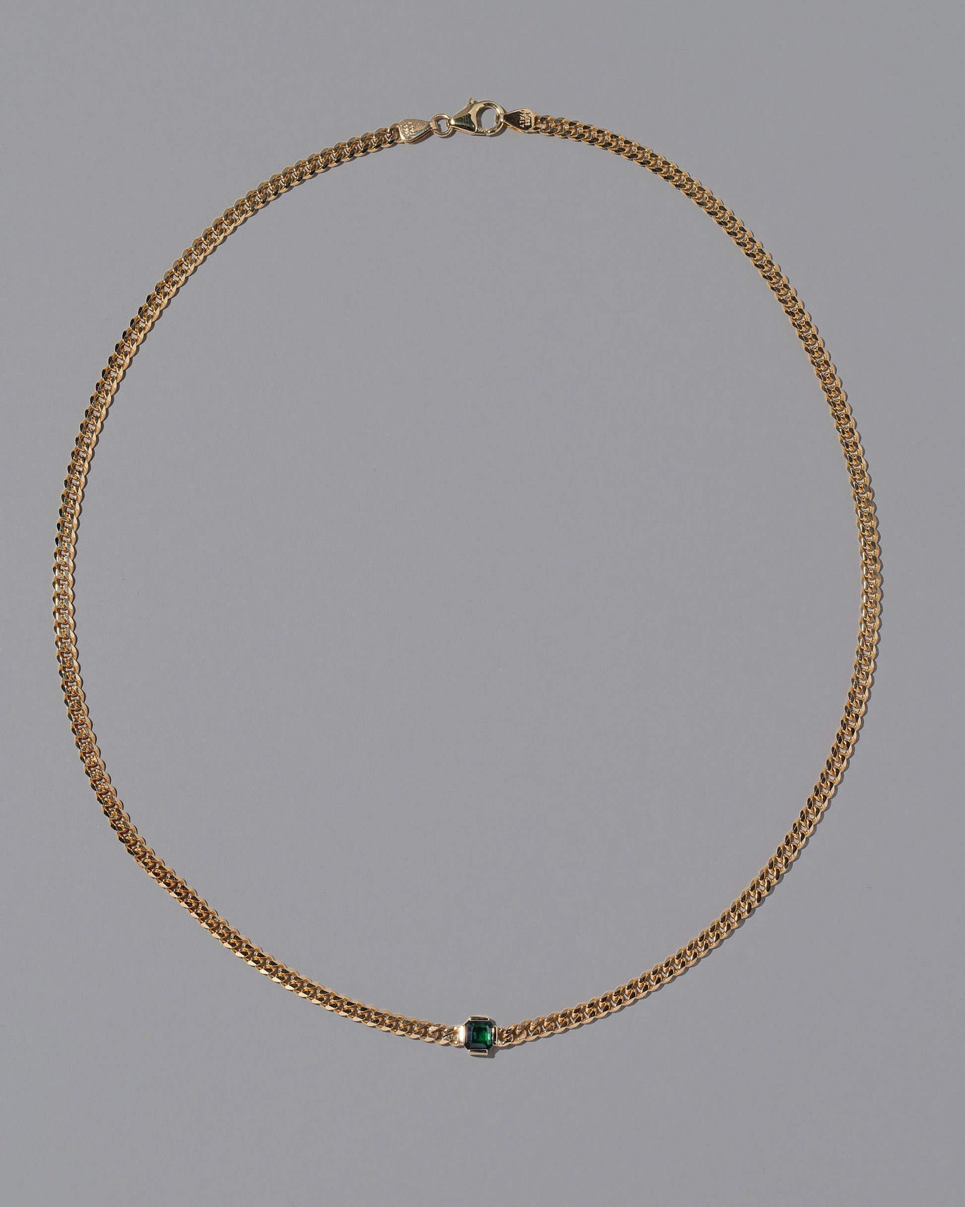 Emerald Fold Necklace on light color background.