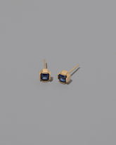 Blue Sapphire Fold Earrings on greycolor background.