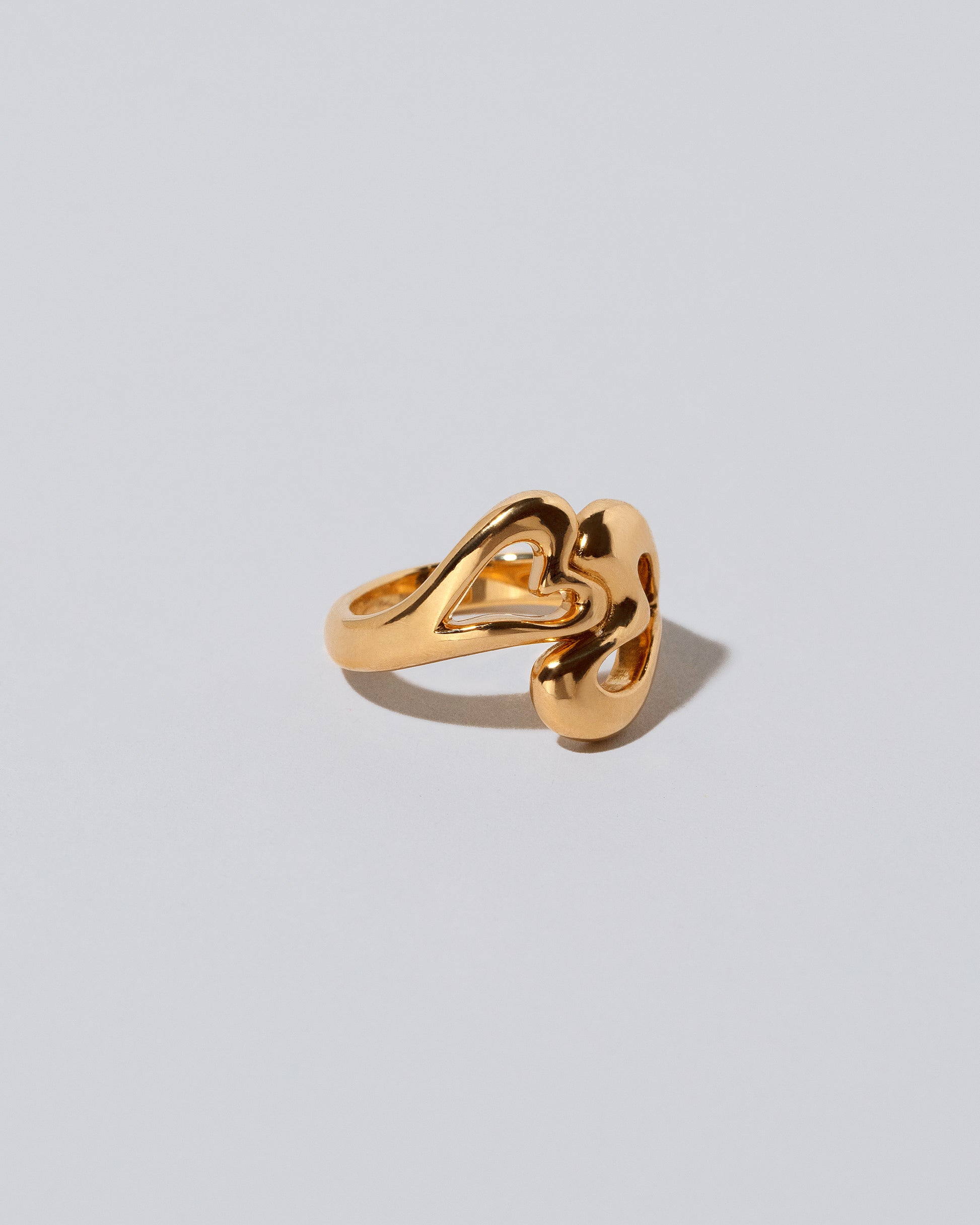 View from the side of the Thousand & One Night Heart Ring on light color background.