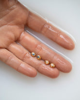 Styled image featuring the Diamond and Sapphire Birthstone Level Stud Earrings.