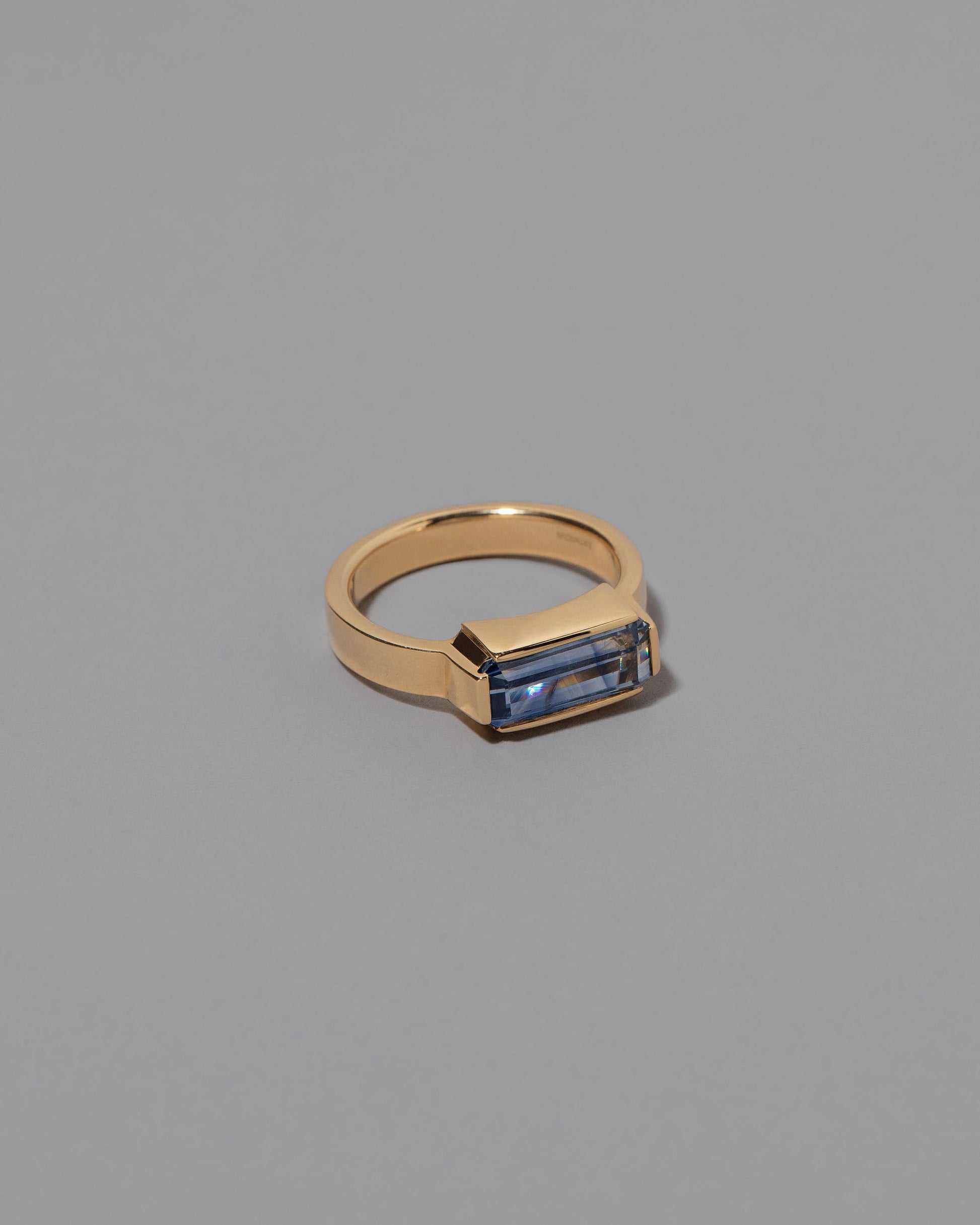 View from the side of the Double Over Ring on grey color background.