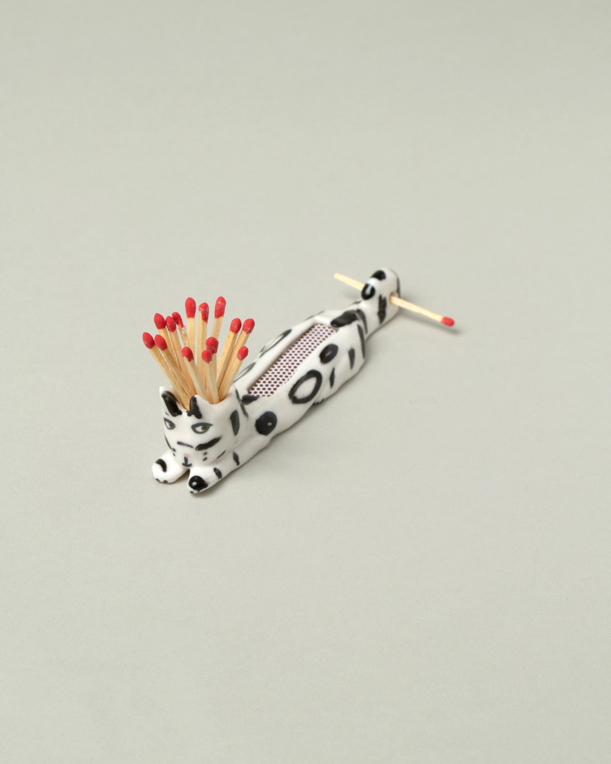 Closeup detail of the Eleonor Boström Black Spots Matchstick Cat on light color background.