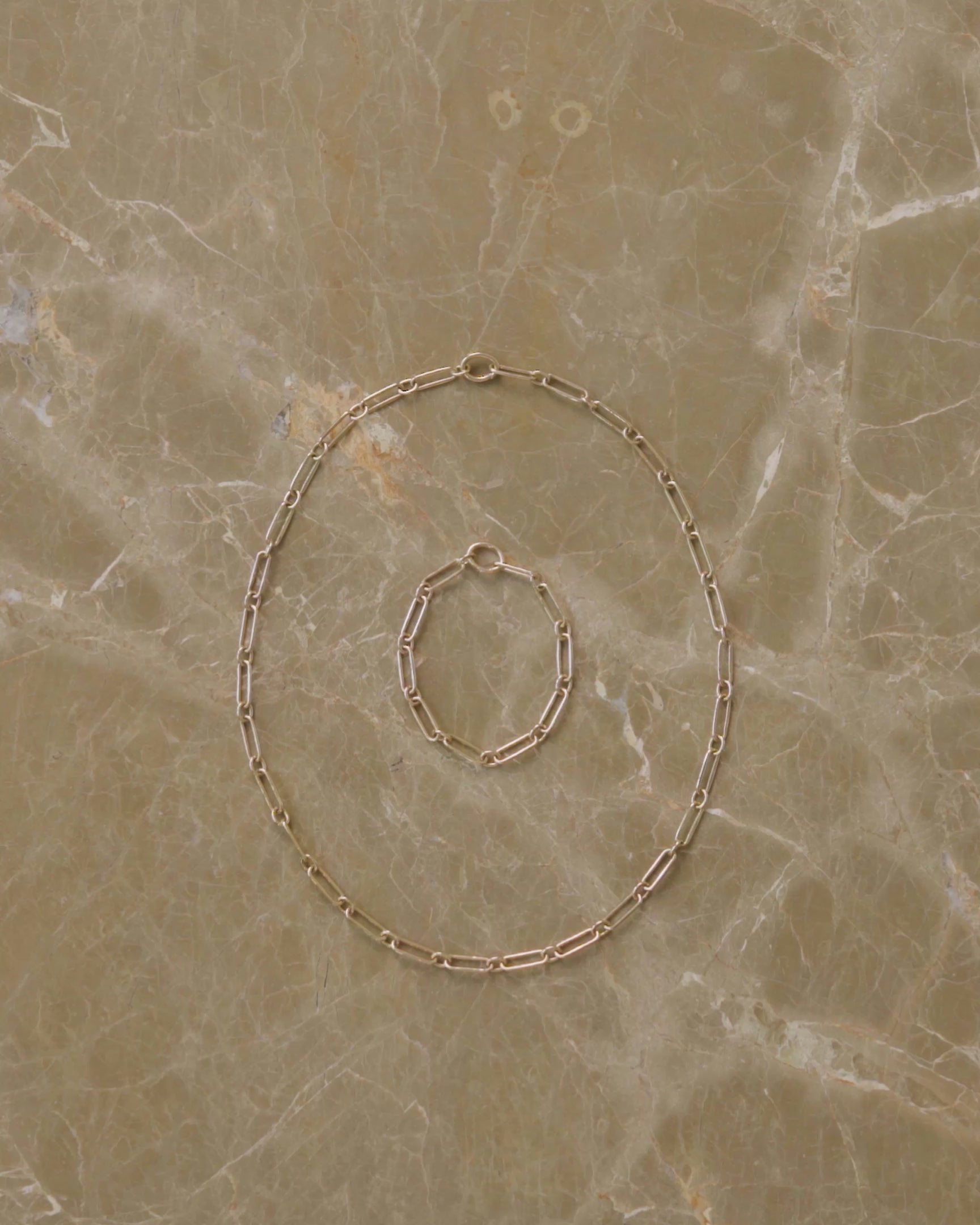How to style and transform the Petite Link Necklace and Petite Link Bracelet, either by using their included Openable Link clasps to clip them into one continuous chain, using their clasps to mix and match charms or to clip on a Grid Swivel Charm Holder to showcase charms like the Diamond Poise Charm and Buttered Toast Charm.