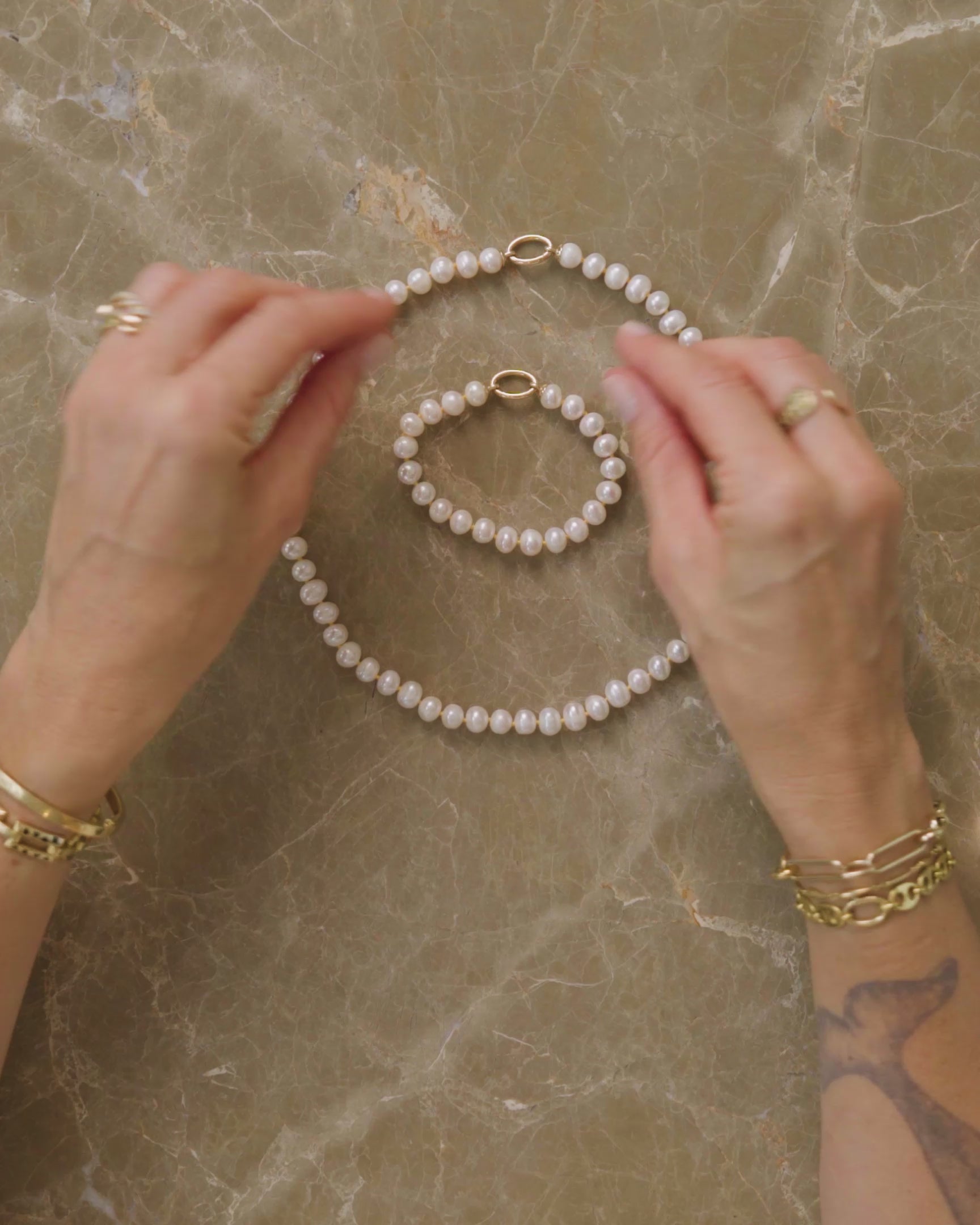 How to style and transform the Pearl Openable Link Necklace and Pearl Openable Link Bracelet, either by using their included Openable Link to clip them into one continuous chain, clipping on the Link Bracelet and Petite Link Necklace for length, using their Openable Link to showcase charms and pendants like the Gold Large Thousand & One Night Heart Charm, or swapping their included Openable Link for an Infinity Openable Link or the Sapphire Gusher Openable Link to wear as two-in-one pendant charm holders.