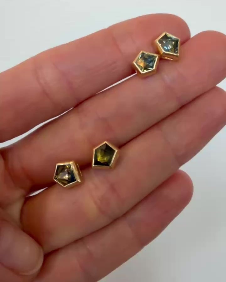 Bicolor Sapphire Geyser Stud Earrings in hand.