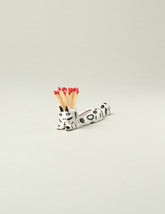 Eleonor Boström Black Spots Matchstick Cat on light color background.