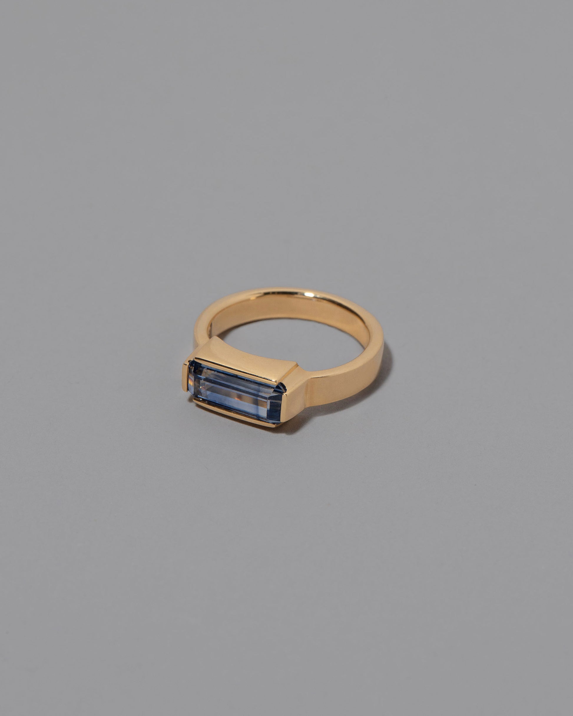 View from the side of the Double Over Ring on grey color background.