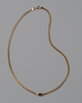 Attachment Necklace on light color background.