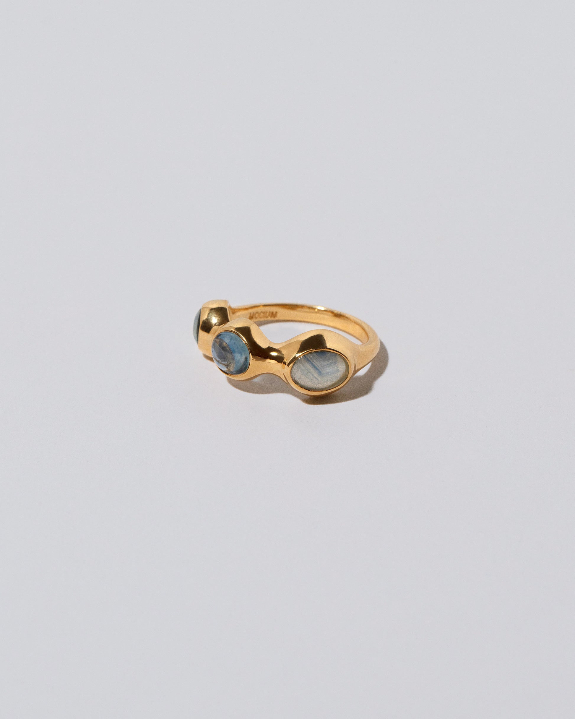 View from the side of the Sword Swallower Ring on light color background.