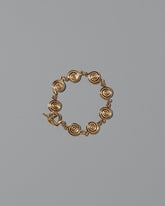 CRZM Gold Serpentinite Bracelet on light color background.
