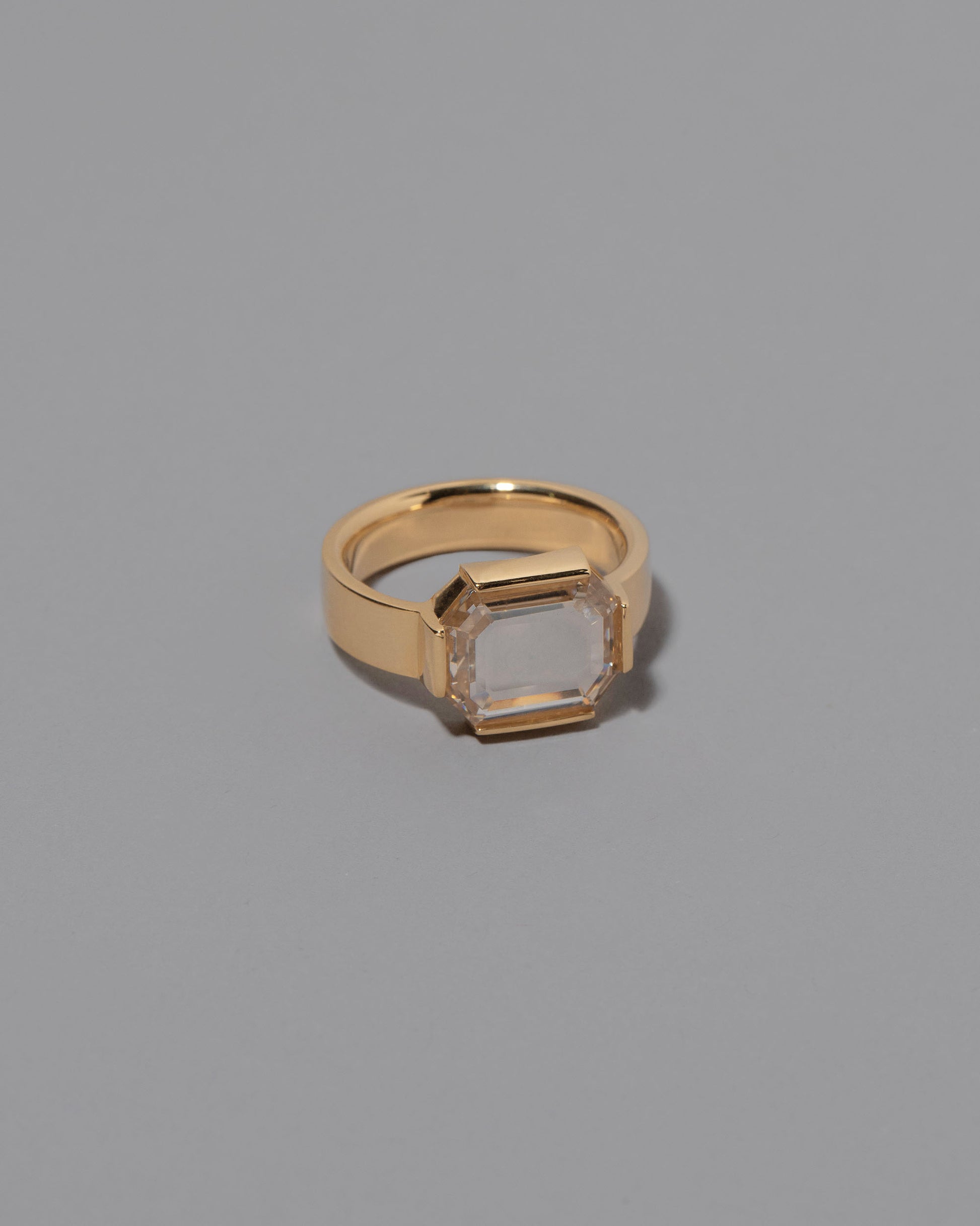 View from the side of the Envelop Ring on grey color background.