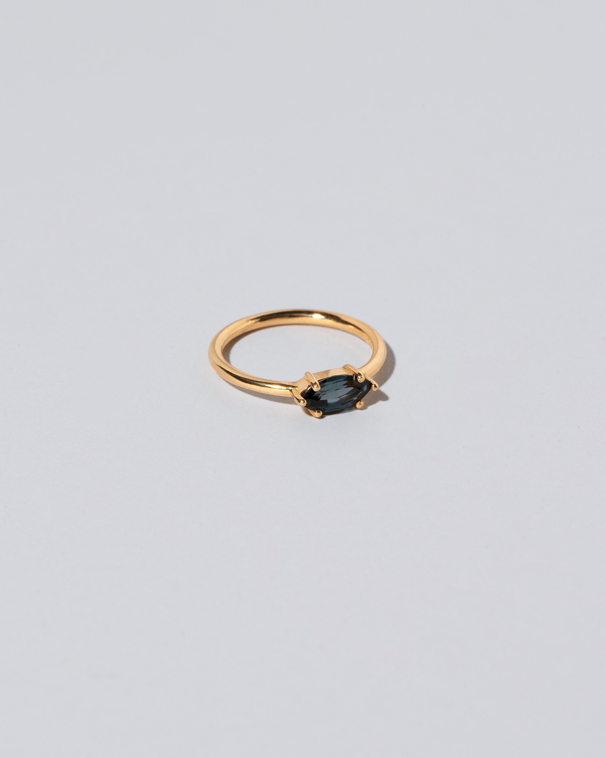 View from the side of the Deep Blue Ouvert Ring on light color background.