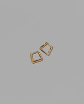 Gold Kink Hoop Earrings on light color background.