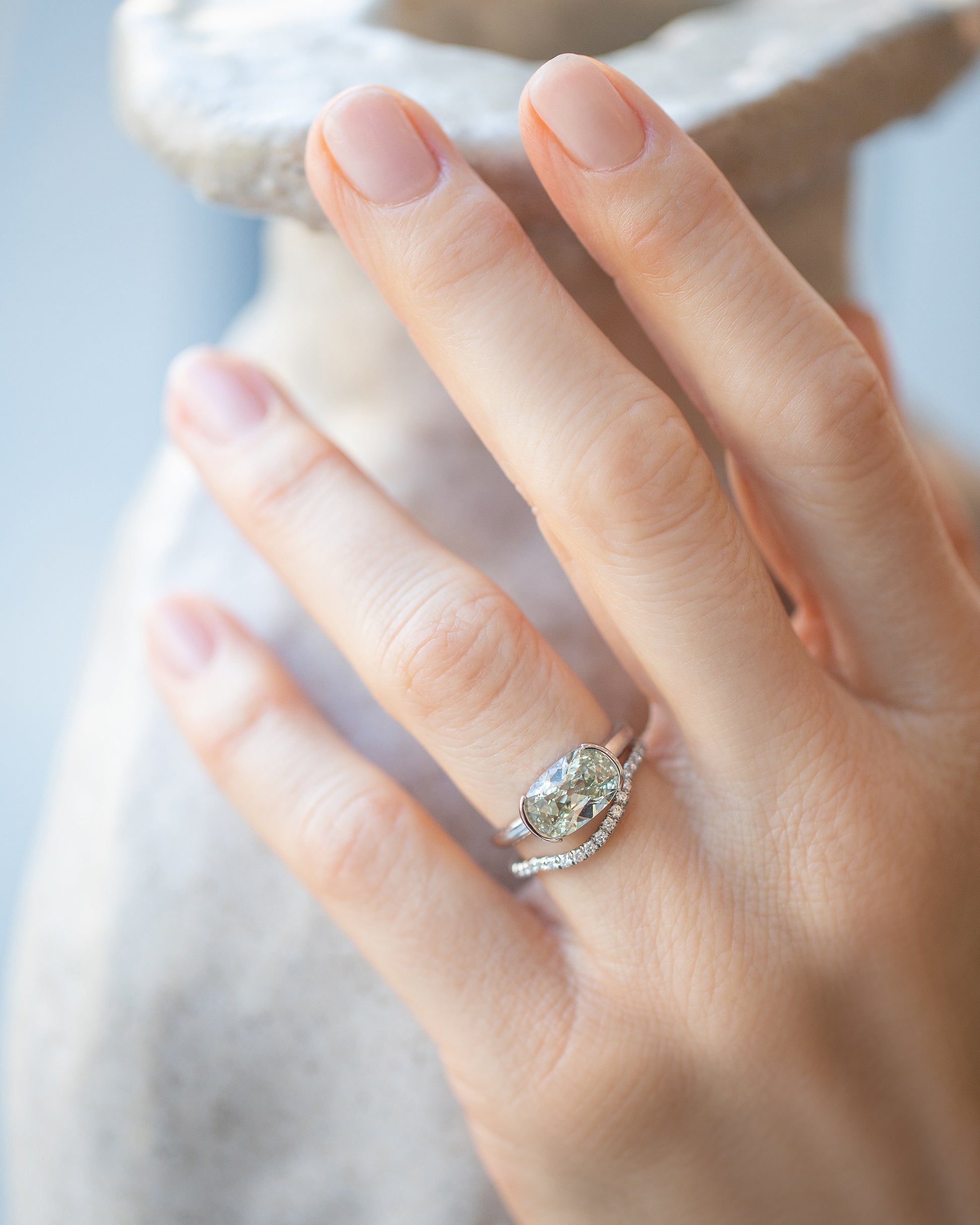Shift Ring and Platinum White Diamond Pavé Mini Curve Band stack on model.